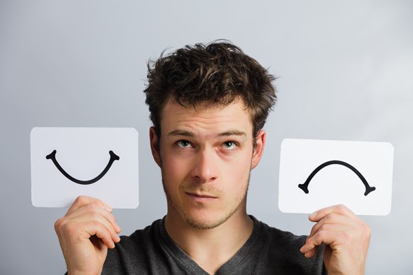 Happy and sad smiley signs held up by customer